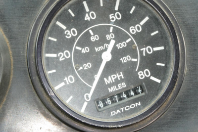 Speedometer gauge showing MPH and KM/H with odometer reading; brand 'DATCON' at bottom; dashboard view.