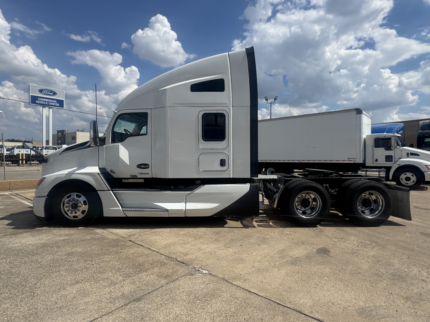 Kenworth T680 tractor with sleeper cab profile, white exterior, side view showing aerodynamic hood and aerodynamic roof, with a day cab and dual rear axles.