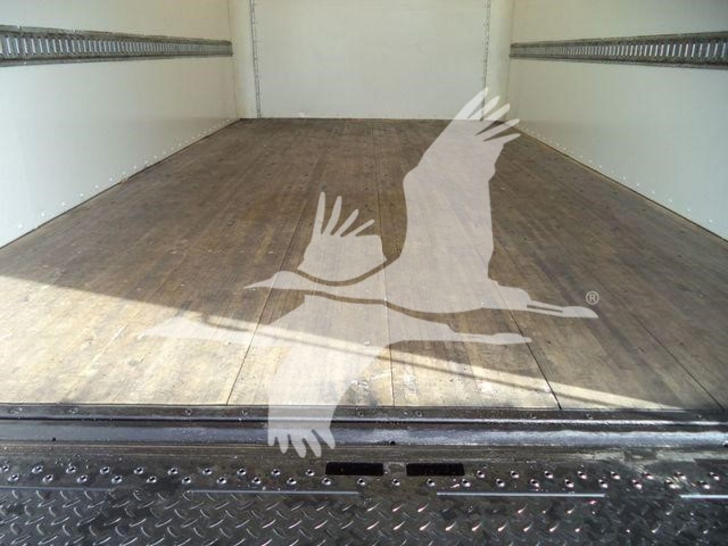 Isuzu NPR-HD box truck cargo area showing wooden floor and side rails