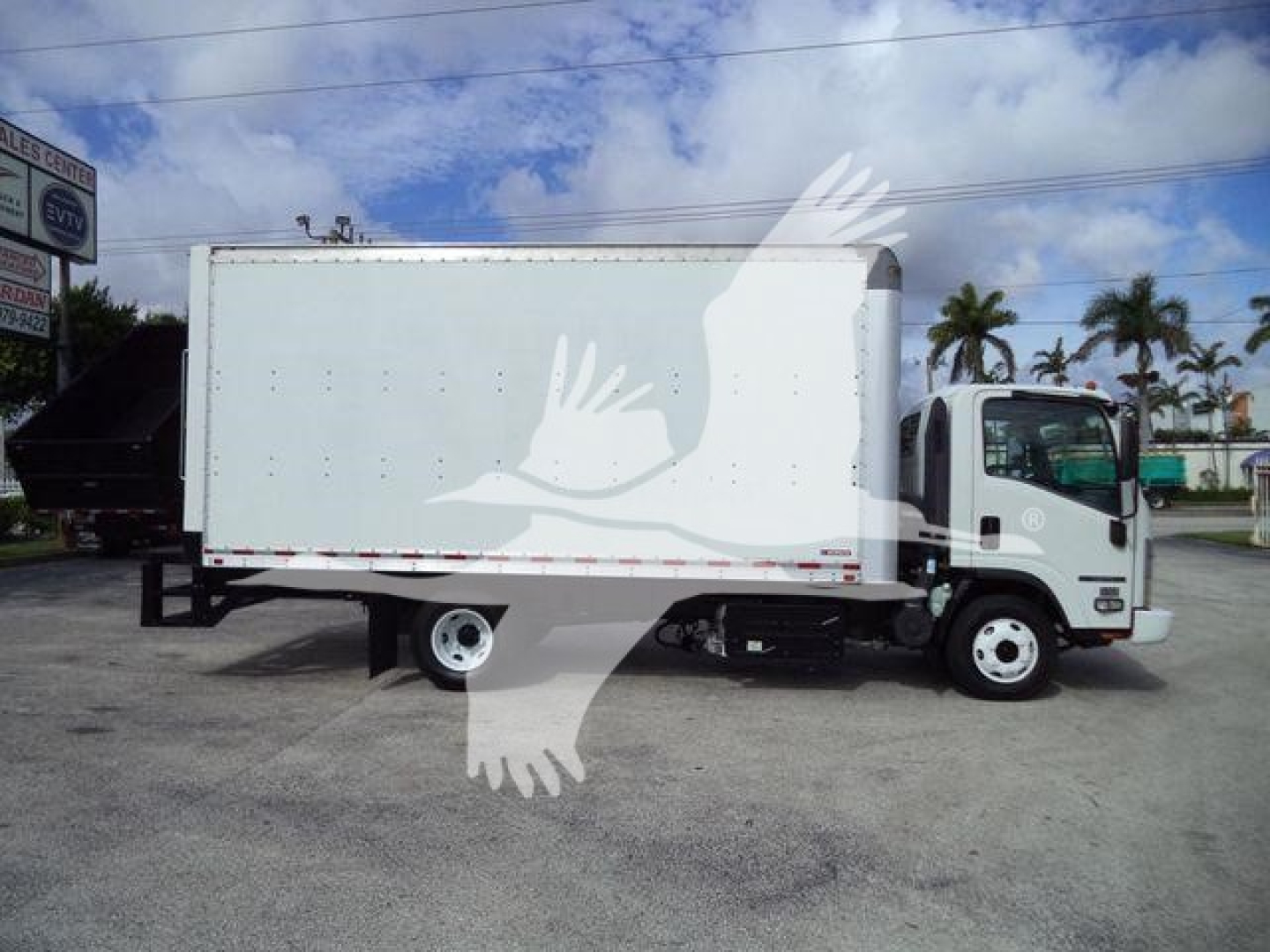 Isuzu NPR HD box truck side view showing cargo box and cab, no legible text or labels visible on the truck.
