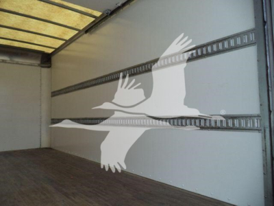 Isuzu NPR HD box truck interior cargo area with smooth aluminum walls and E-track rails, empty cargo space.
