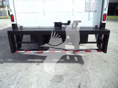 Isuzu NPR-HD truck rear with black diamondplate steel bumper/steps, tailgate area, and reflective safety striping.