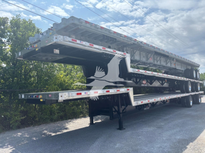 Trailer with multiple stacked drop deck sections for a Dorsey combo drop, showing new trailers in a yard.