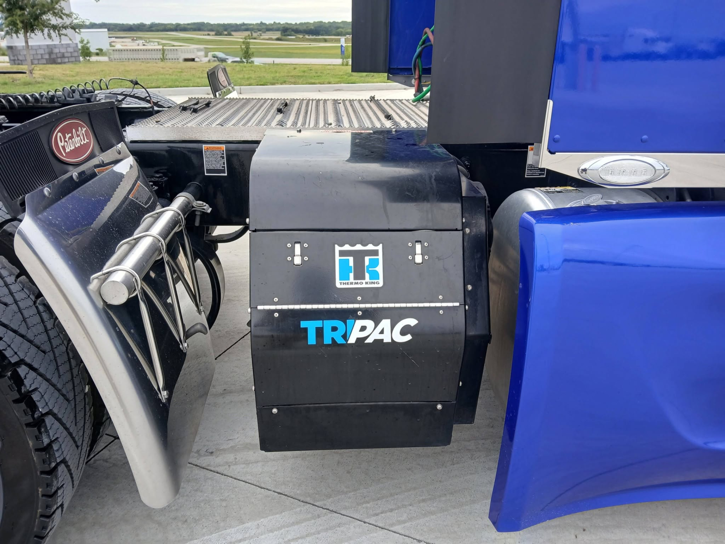 Truck side setup showing TRPAC toolbox mounted between cab and sleeper on a 2025 Peterbilt 579 conventional sleeper. Visible markers include TRPAC logo and white text on black box.