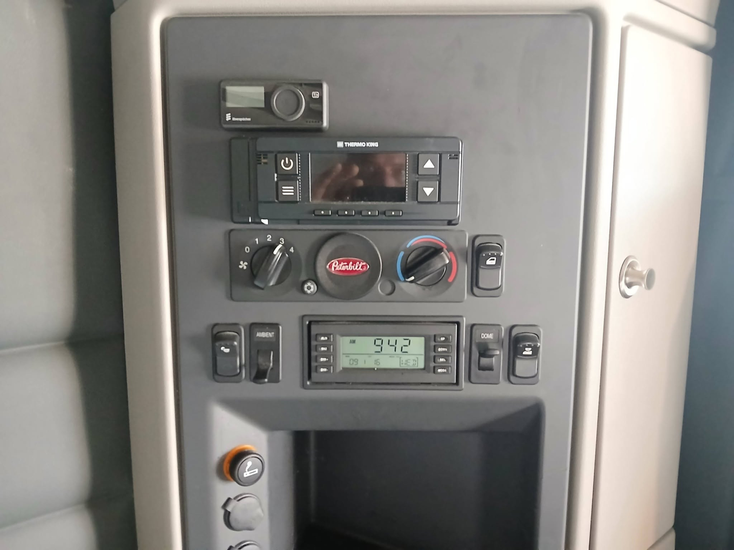 Dashboard and control panel of a Peterbilt truck cab showing multiple gauges and switches.