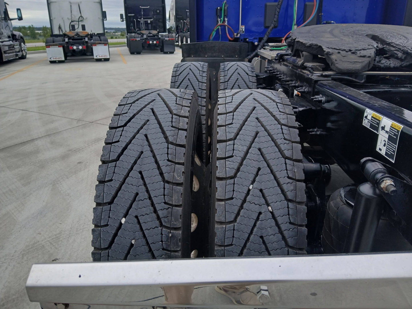 Peterbilt 579 truck chassis with dual rear axles and high-traction tires, visible frame rails, and part of the cab mounting area.
