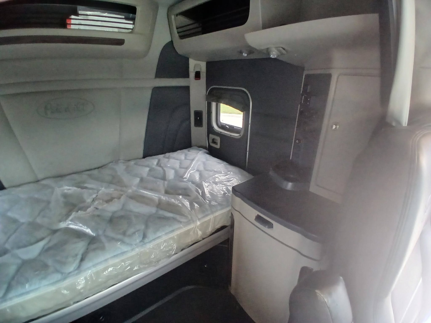 Peterbilt 579 truck sleeper interior with bed and cabinetry visible