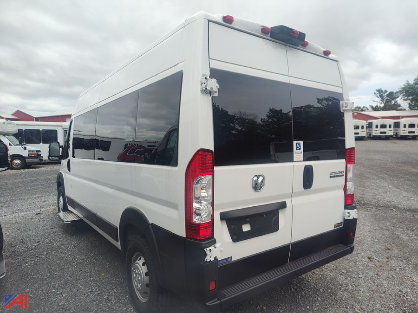 Ram ProMaster wheelchair van rear- and side-view showing cargo van with tinted windows and accessibility sticker on rear doors.
