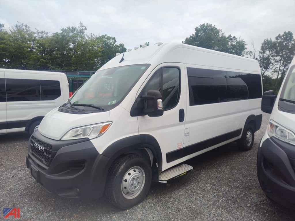 Ram ProMaster wheelchair van in white, side view showing driver-side door, side step, and windows.