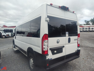 Ram ProMaster wheelchair van rear- and side-view showing cargo van with tinted windows and accessibility sticker on rear doors.