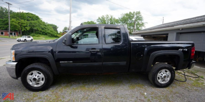Chevrolet Silverado 2500HD extended cab pickup truck side view showing cab, long bed, and dual rear wheels with black exterior