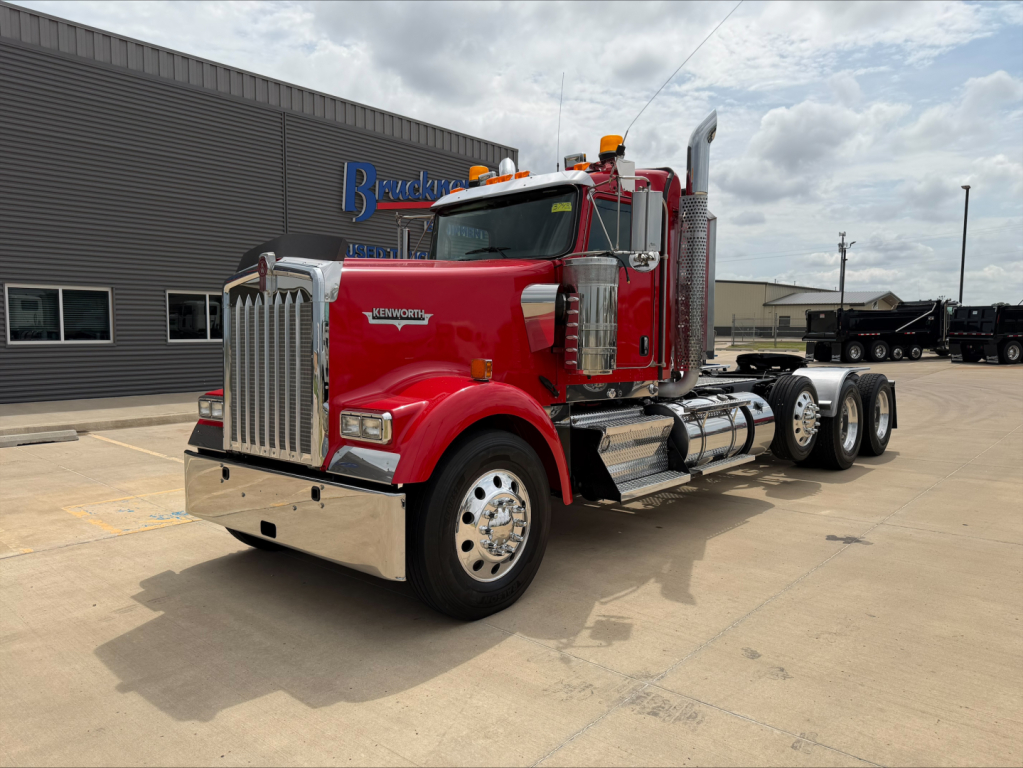 Kenworth W900L conventional daycab truck in red with chrome exhaust stacks and dual rear axles.