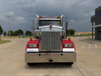 Front view of a 2022 Kenworth W900L conventional daycab truck showing chrome grille, bumper, and lights.