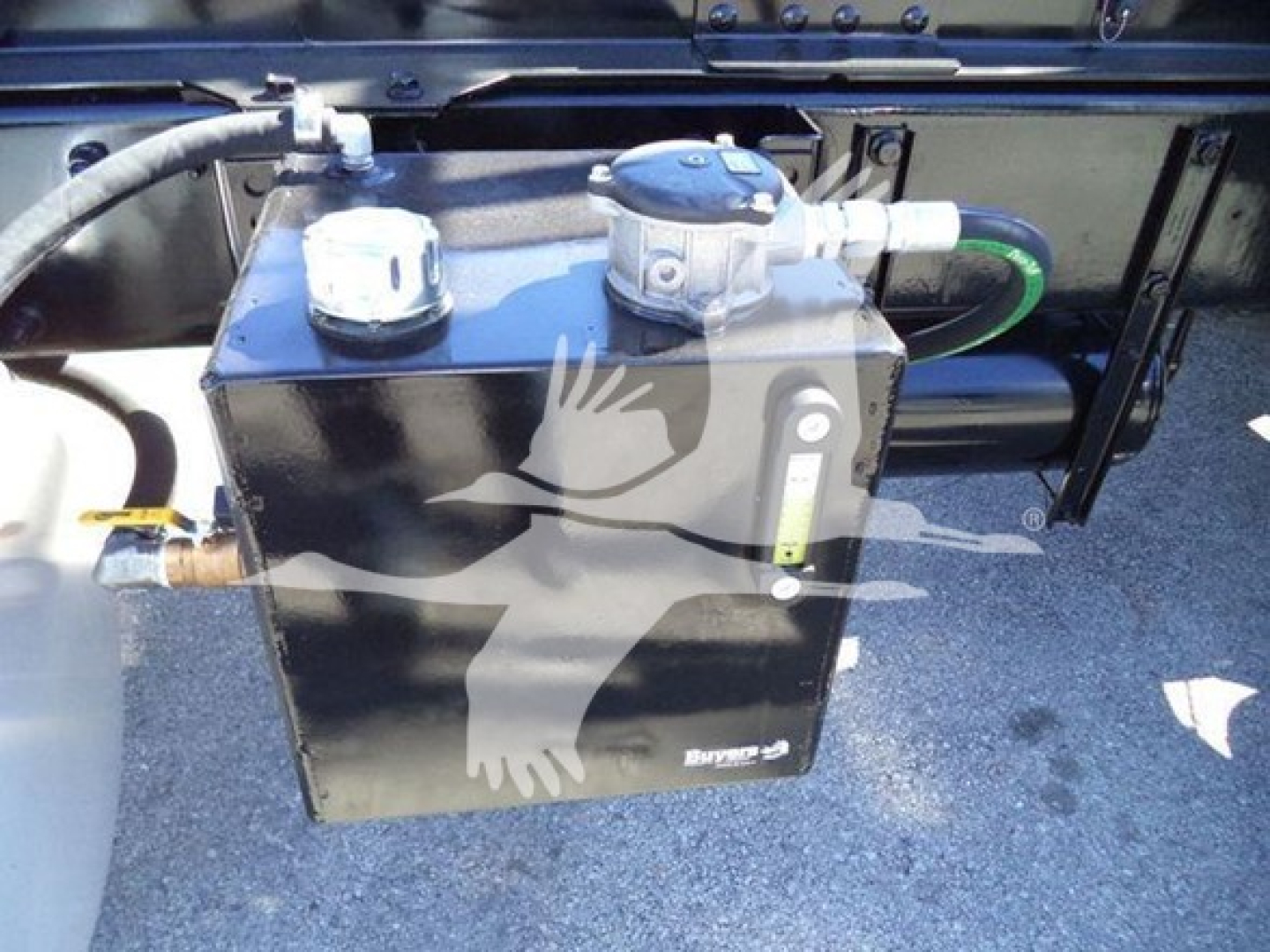 Peterbilt 337 truck underside showing a black rectangular fuel/auxiliary tank with metal fittings and hoses.