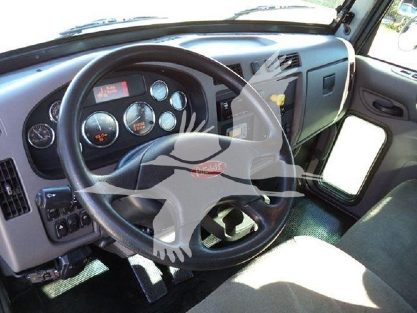 Peterbilt 337 dashboard and steering wheel interior with gauges visible; includes Robert Peterbilt logo on steering wheel