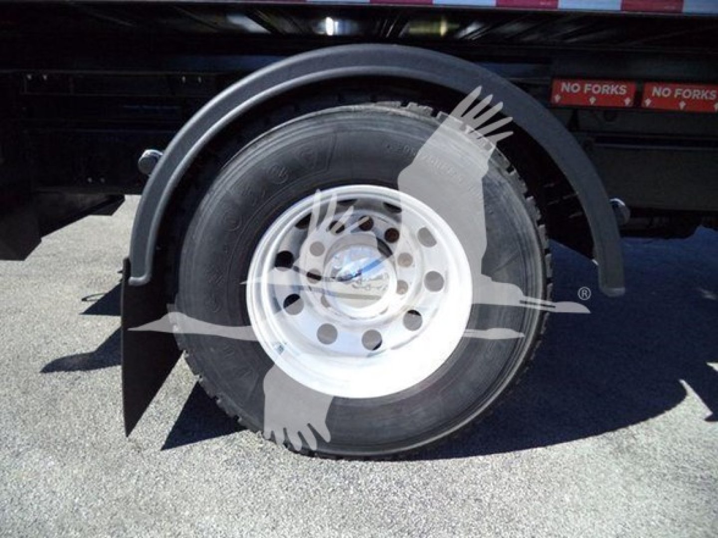 Peterbilt 337 wheel and fender showing steel wheel with tire and mud flap