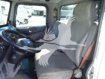 Interior of a Peterbilt truck cab showing steering wheel, driver seat, and front window. No visible labels or peripherals legible.