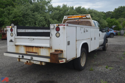 Ford F-550 Super Duty utility truck rear view with utility bed and service compartments.