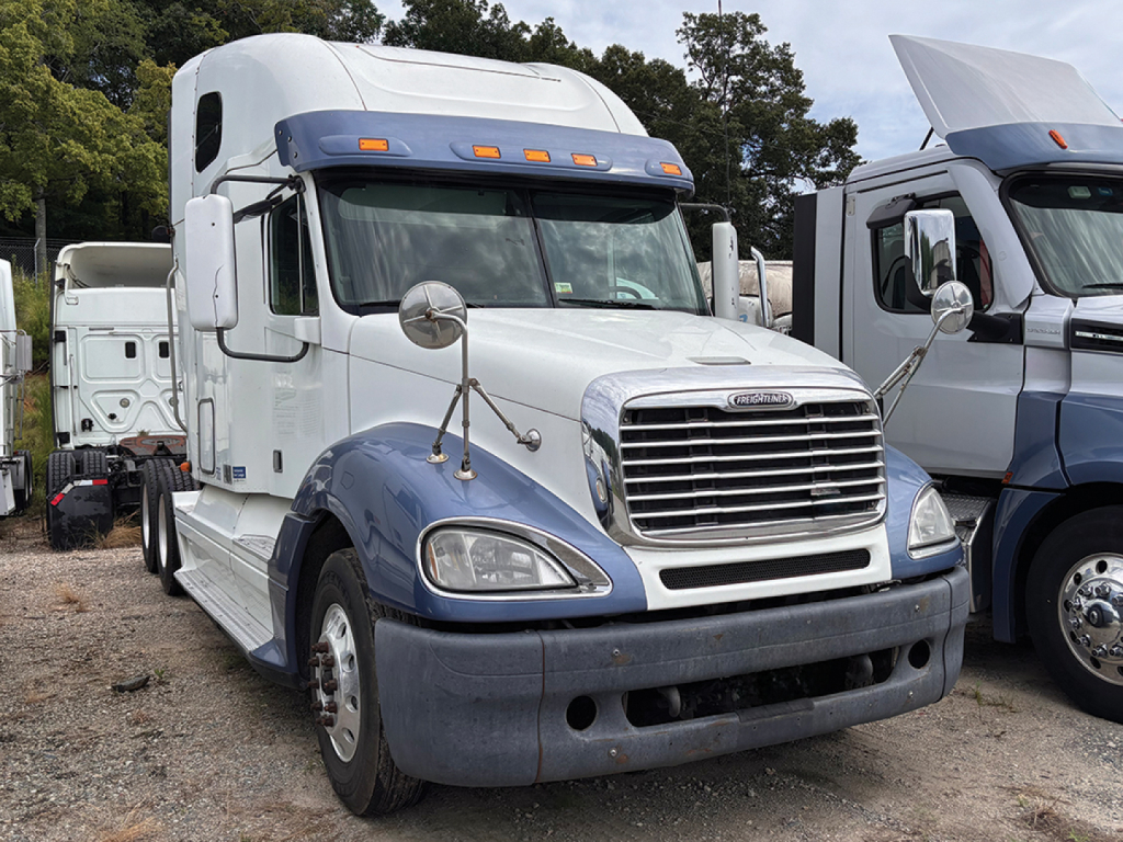 Freightliner CL120 Columbia truck cab and front end with grille, headlights, and blue bumper; white cab with blue lower panels.