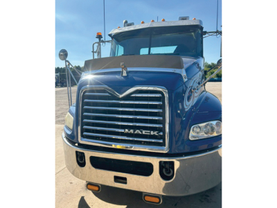Front view of a blue 2014 Mack CXU613 truck showing chrome grille and bumper, headlights, and hood emblem.