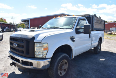 2008 Ford F-250 Super Duty pickup with single rear wheel, white cab, black grille, heading toward left, utility bed, front view showing Ford emblem and headlights.