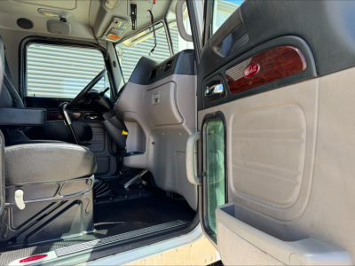  cab interior of 2015 Peterbilt 389 showing dashboard and steering wheel with door panel