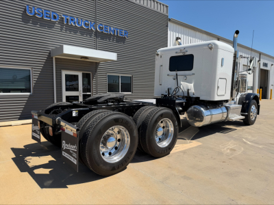 Peterbilt 389 tractor cab with dual rear axles and sleeper, chrome wheels, front of used truck center lot, VIN 1XPXDP9X7FD299952 visible.