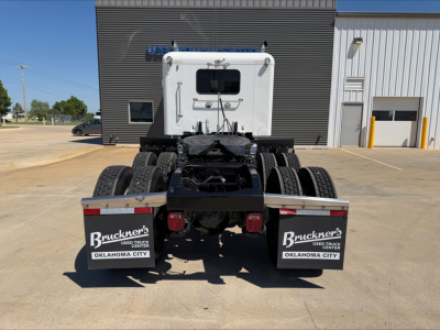 Peterbilt 389 tractor cab rear view showing fifth wheel, dual rear axles, and mud flaps with Bruckner’s Oklahoma City branding.