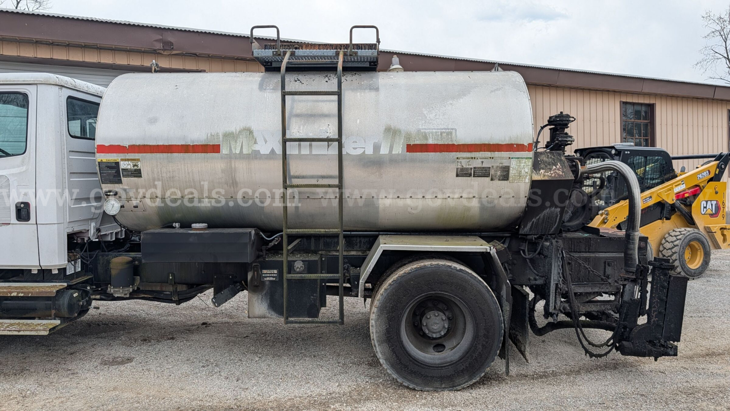 Tank truck on Freightliner FL70 showing 1000-gallon or similar tank with rear access ladder and pump hardware