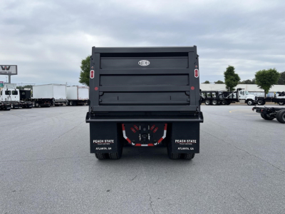 Dump truck bed rear showing Western Star logo and tailgate, black dump truck with dual tail lights, Peach State Atlanta GA mud flaps.