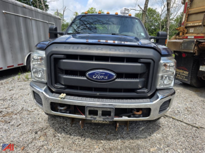 Ford F-250 Super Duty front view with utility body showing large grille, bumper guard, and towing hitch.