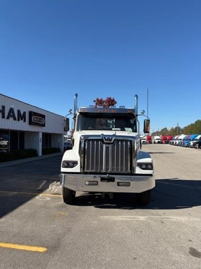 Front view of a white Western Star 49X day cab truck in a dealer lot.