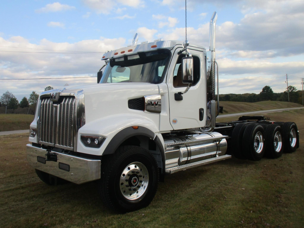 Western Star 49X day cab truck in white, front three-quarter view showing chrome grille, wheel, and exhaust stacks.