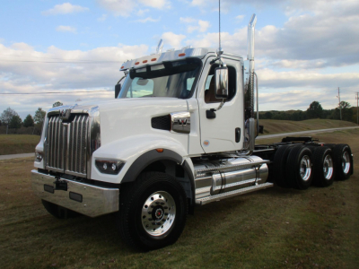 Western Star 49X day cab truck in white, front three-quarter view showing chrome grille, wheel, and exhaust stacks.