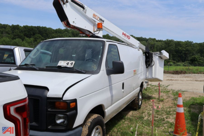 Ford E350 bucket truck in-service van with bucket lift extended on the bed, white, side view showing bucket components and hazard cones.