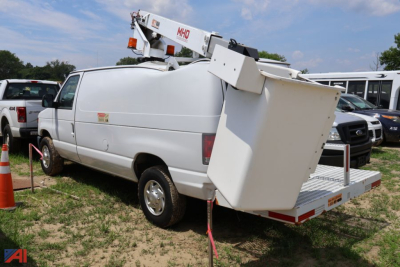 Ford E350 bucket truck utility van with mounted bucket lift in service position showing rear platform and crane arm