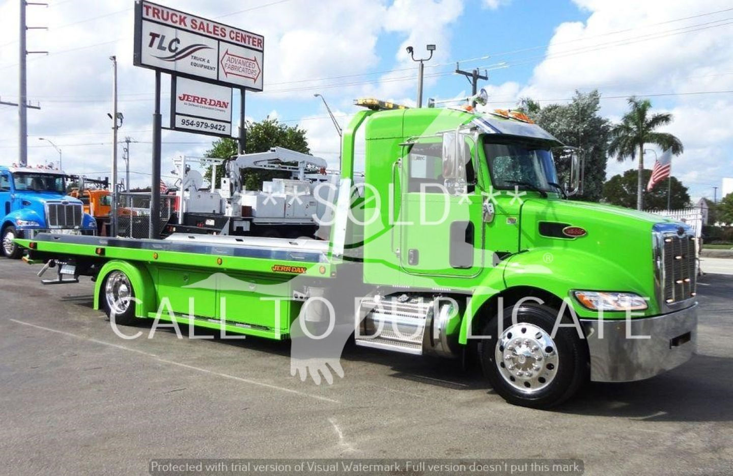 Green Peterbilt 337 rollback tow truck side view with flatbed and chrome grille showing J47210 stock number.