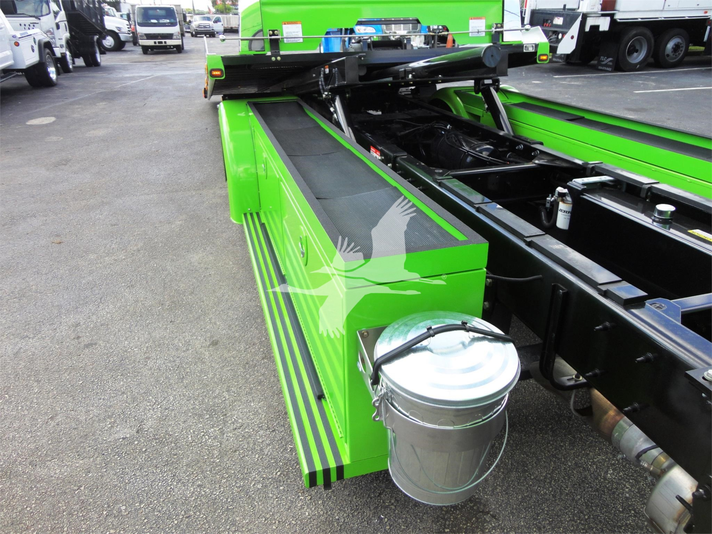 Green Peterbilt 337 rollback truck chassis with metal tool bucket attached, side view showing bright green body panels and black frame.