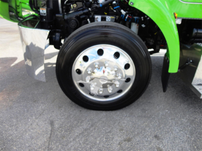 Peterbilt 337 rollback truck front wheel with chrome hub and green fender visible