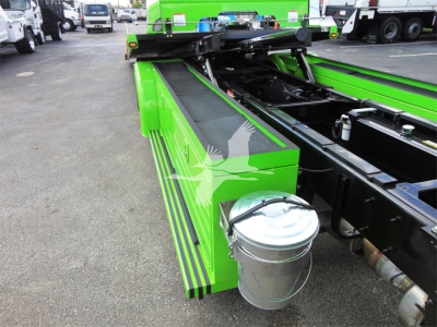 Green Peterbilt 337 rollback truck chassis with metal tool bucket attached, side view showing bright green body panels and black frame.