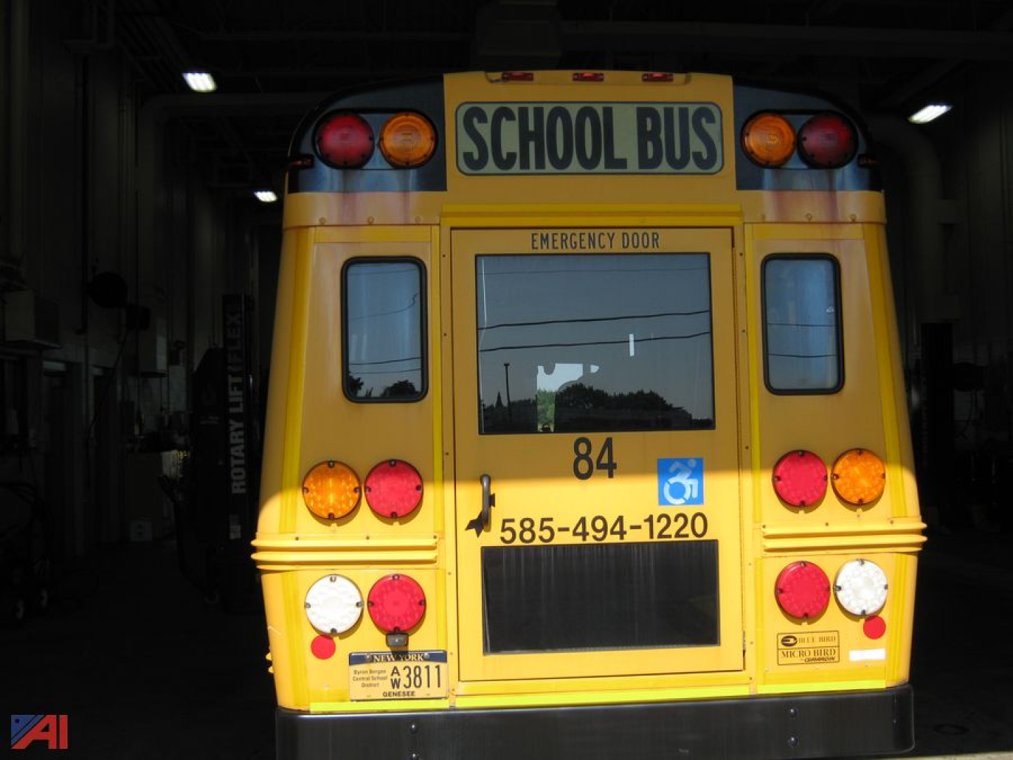 Ford 2015 Ford 350HD Transit Bus with Wheelchair Lift back view showing school bus signage and emergency exit