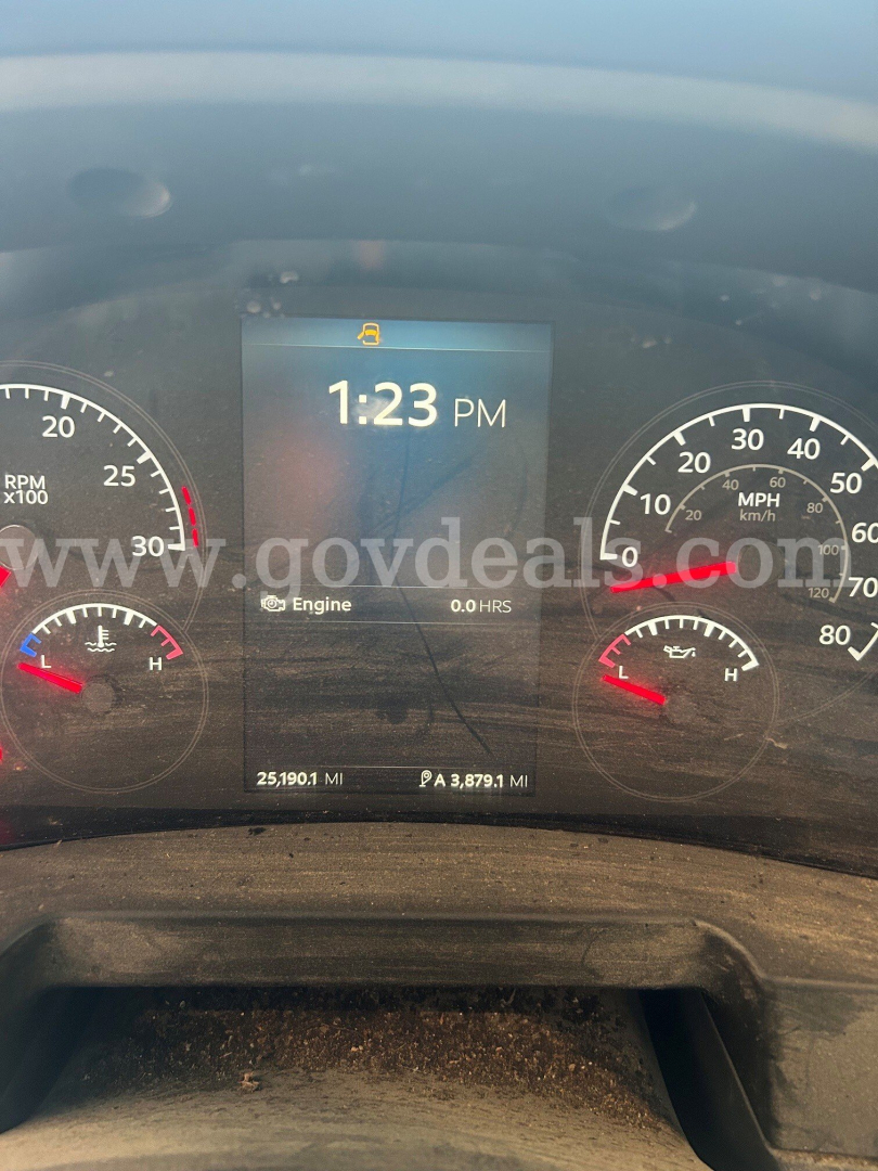 Kenworth T480 instrument cluster display showing time 1:23 PM with engine hour readout and gauges. Visible text includes engine 0.0 HRS and mileage 25,190.1 MI, 3,879.1 MI trip, and some dashboard icons.