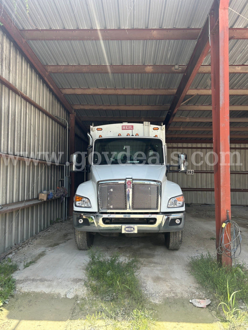 Kenworth T480 truck front view in a metal shelter with grille, headlights, and license plate area visible.