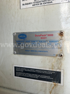 Label plate on equipment showing HeIl DuraPack 5000 BODY with warranty text and serial date plates.