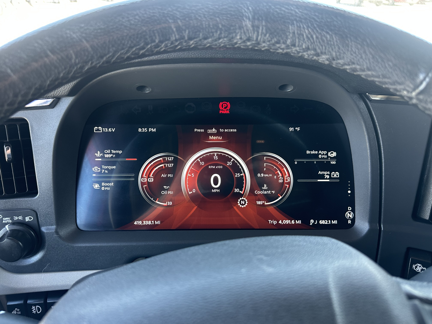 Dashboard view of a 2023 Peterbilt 579 showing digital instrument cluster with speedometer, fuel gauges, and warning icons.