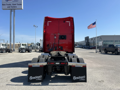 Rear view of a 2023 Peterbilt 579 truck tractor showing fifth wheel, rear lights, and mud flaps with Buckner's Equipment branding.