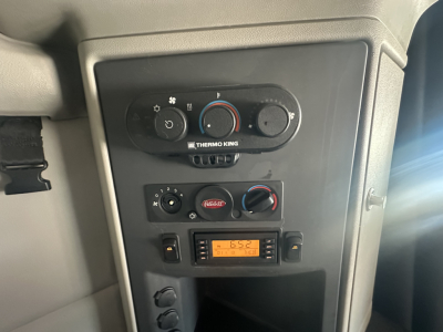 Peterbilt 579 dash panel showing climate controls and a Thermo King auxiliary control panel with an orange digital readout.