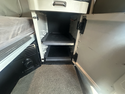 Peterbilt 579 cab interior showing empty storage compartments in the sleeper area with open cabinet doors