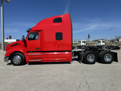 Peterbilt 579 tractor in red side view showing sleeper cab and 3-axle configuration with chrome wheels.