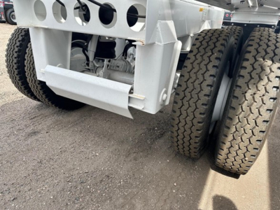 Ranco air ride bottom dump trailer axle and suspension showing dual tires and undercarriage components.